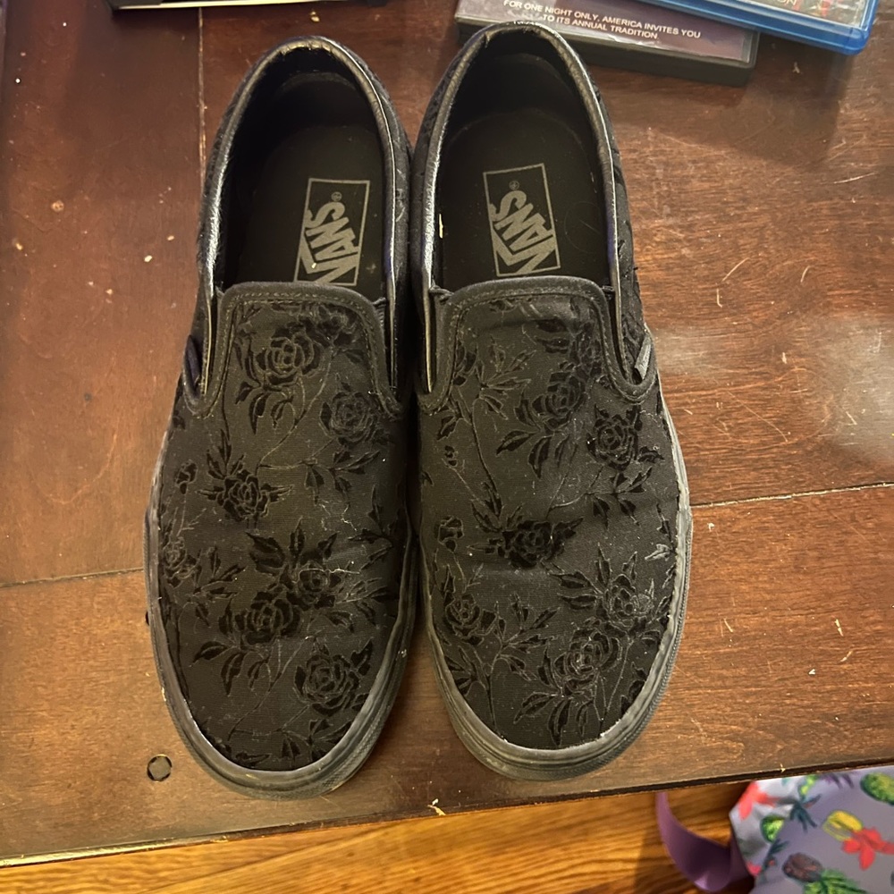 Black vans with roses.
